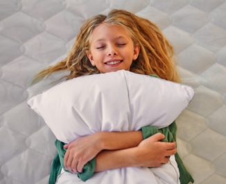 Girl laying with a pillow. A Good Bed And Pillow.