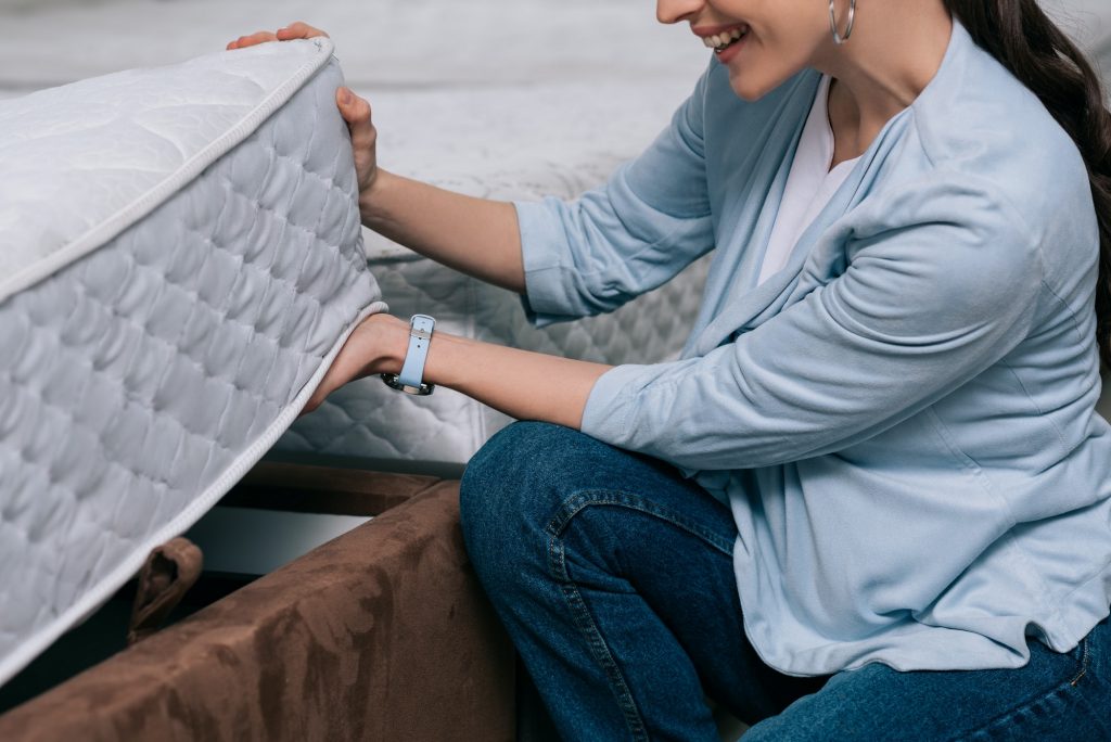 Woman checking out a two-sided mattress.